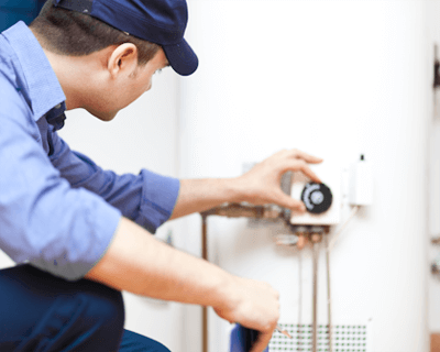 gas fitter adjusting hot water heater controls
